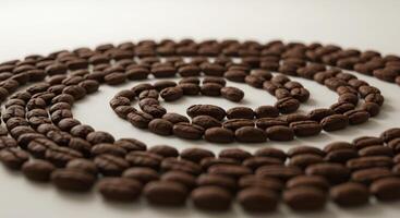 Coffee beans arranged in a spiral shape on a white surface photo