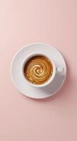 A cup of coffee on a saucer on a pink background photo