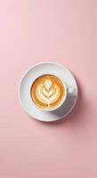 A cup of coffee with a leaf design on top photo