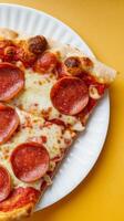 Slice of pizza over bright color background photo