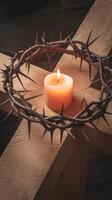 Candle on the cross with crown of thorns photo