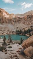 A lake surrounded by rocks and trees in the mountains photo