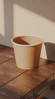 A brown paper bowl sitting on a table photo
