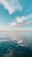 A blue sky with clouds and water photo