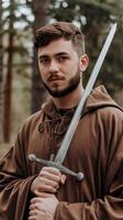 A man in a brown robe holding a sword photo