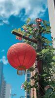 A red lantern hanging from a pole photo