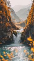 A waterfall in the mountains surrounded by trees photo