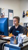 A man wearing a headset at a computer photo