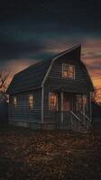An old house in the middle of a field at night photo