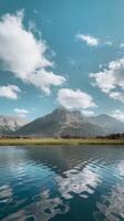 A lake with mountains and birds flying over it photo