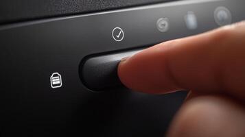 Finger pressing power button to activate car security system photo