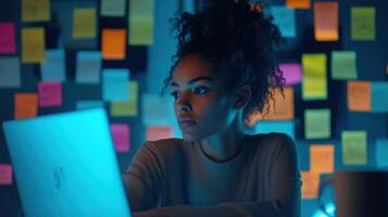Focused female programmer working late at night on cyber security project photo