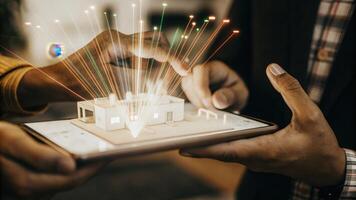 A closeup of hands manipulating a 3D holographic business model with colorful rays of light creating a dynamic environment showcasing the creativity in global innovation.. photo