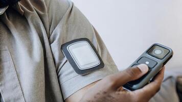 A detailed view of a skin patch device providing realtime health monitoring capturing sensors that read biometric data and display it on a handheld device emphasizing advanced. photo