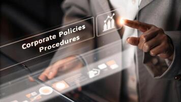 A closeup view of a holographic touchscreen interface with a users hands manipulating digital elements depicting corporate policies and procedures.. photo