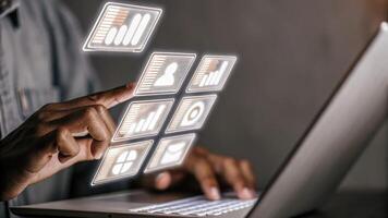 A medium closeup of shimmering holographic icons representing various data sources being integrated with a user gesturing to combine them into a cohesive dashboard.. photo