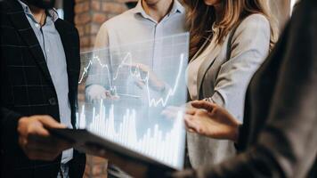 A group of business strategists watches a floating holographic projection of market trends actively debating the implications of realtime analytics on their upcoming projects.. photo