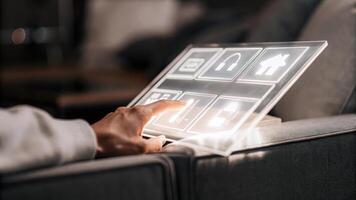 A closeup of a user interacting with a sleek transparent touchscreen where holographic icons and menus float above the surface illustrating intuitive navigation.. photo
