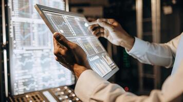 A closeup of a researchers hands manipulating a floating holographic interface with vibrant graphs and realtime data visualizations illustrating blockchain transactions in a. photo