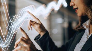 A closeup of a woman interacting with a holographic interface her fingers reaching out to manipulate swirling data visuals that represent market trends.. photo