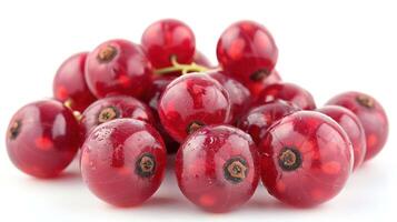 A cluster of shiny red currants against a white background. photo