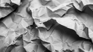 A close-up of crumpled gray paper, showcasing texture and depth. photo