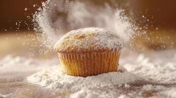 A freshly baked muffin surrounded by a cloud of flour, emphasizing its texture and freshness. photo