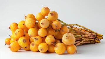 A bunch of bright yellow fruits with a textured surface arranged on a white background. photo