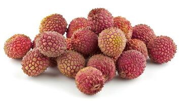 A pile of fresh lychee fruits showcasing their textured, reddish skin. photo