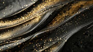 A close-up of textured black and gold waves with sparkling elements. photo