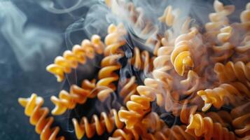 A close-up of spiraled pasta with steam rising, showcasing its texture and warmth. photo