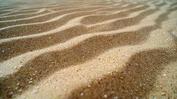 Close-up view of textured sandy surface with gentle ripples and shadows. photo