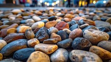 A close-up view of various smooth pebbles scattered on a surface. photo