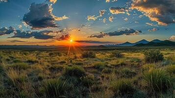 A stunning sunset over a vast landscape with mountains in the distance and vibrant clouds. photo