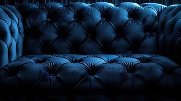 A close-up view of a plush, tufted blue sofa, emphasizing its texture and design. photo