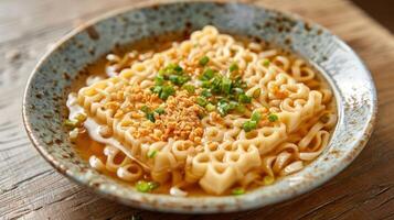 A bowl of ramen noodles topped with green onions and crushed peanuts in a rustic setting. photo