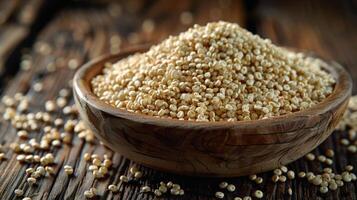 A wooden bowl filled with quinoa grains, surrounded by scattered grains on a rustic wooden surface. photo