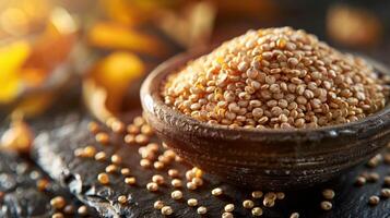 A bowl of quinoa grains on a textured surface, surrounded by autumn leaves. photo