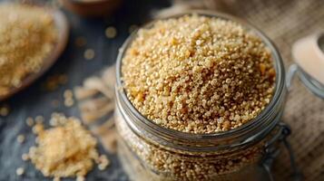 A close-up of a jar filled with quinoa grains, showcasing its texture and color. photo
