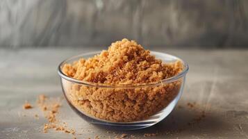 A bowl filled with brown sugar, showcasing its texture and color. photo