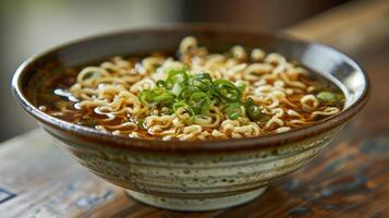 A bowl of ramen with noodles and green onions in a rustic dish. photo