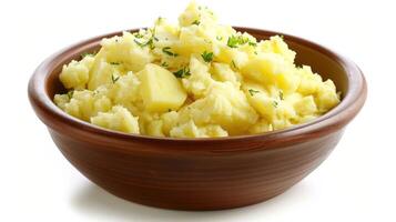 A bowl of creamy mashed potatoes topped with butter and herbs. photo