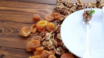 Clean empty plate and Nuts, dried apricots and prunes video