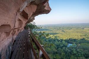 An iconic wooden stairs on Wat Phu Tok temple a quiet mountain and a place of peace and respect in Bueng Kan province of Thailand. photo
