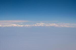 Mt.Everest with others Himalayas mountains range look through airplane window during flight from Bangkok to Kathmandu, Nepal. photo