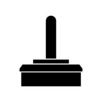 A black and white icon of a button on a table vector