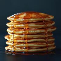 Stack of pancakes with syrup dripping down, creating delicious look photo