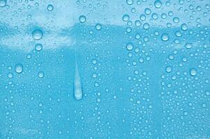 Rain water droplets with ocean blue color background suitable for wallpaper photo