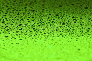 Rain droplets on a dark green color background with customizable space for text or ideas photo