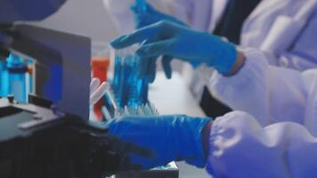A person in a lab coat is working on a test tube video